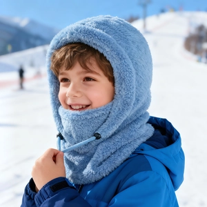 Close-up of child light blue balaclava with adjustable drawstring in snowy outdoors