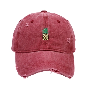 Distressed wash red baseball cap with pineapple embroidery and vintage torn details