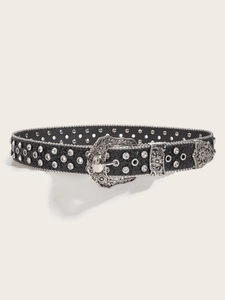 Detail of black rhinestone belt with vintage silver floral buckle and metal eyelets