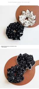 Macro detail of polka dot bow scrunchies with elegant ruffled fabric and fine stitching