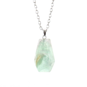 Macro shot of natural green fluorite coffin pendant on a thin silver chain
