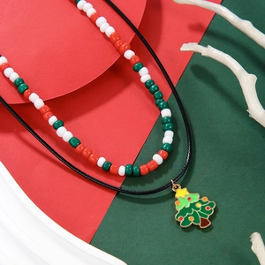 Detail of Christmas beaded necklace featuring an enamel metal Christmas tree pendant charm