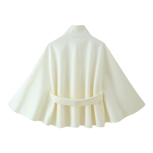 Detail view of the back of a cream loose stand-collar cloak coat with a waist belt