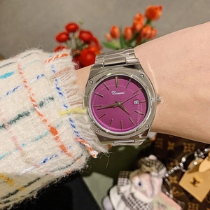 Fashionable woman wearing purple dial watch with silver steel band and date calendar