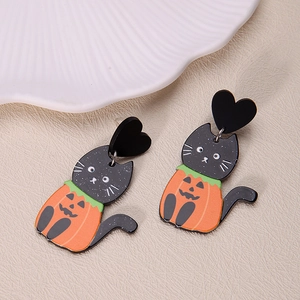Detail of Halloween drop earrings featuring acrylic black cat and orange pumpkin charms