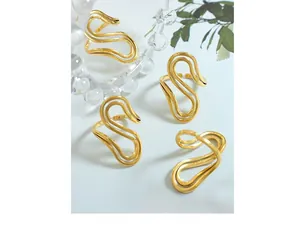 Detail showing set of S-shaped wave rings with polished 18K gold finish and open band