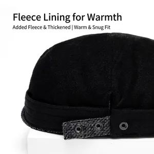 Rear view of black wool flat cap with grey adjustable strap and metal eyelet details