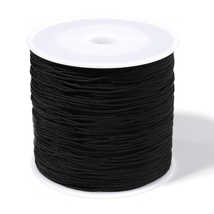 Detailed view of 0.8mm black braided cord neatly wound on a spool for DIY jewelry