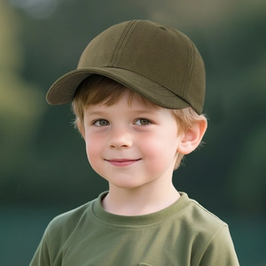 Close-up of olive green cotton baseball cap worn by a child in an outdoor setting