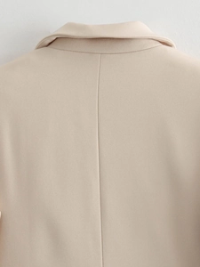 Detail of premium beige blazer showing high-quality twill fabric and refined back stitching