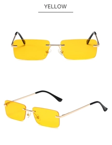 Detail view of yellow rimless rectangle sunglasses with metallic gold temple arms