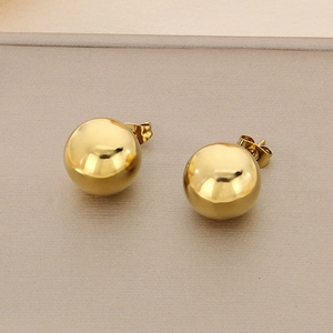 Detailed close-up of polished 18K gold-plated stainless steel ball stud earrings on beige