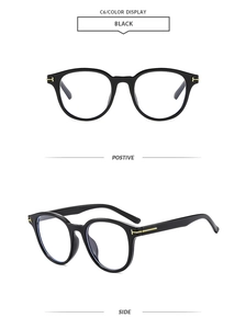 Detail view of square black sunglasses with iconic gold T-shaped temple metal decoration