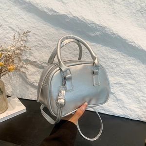 Silver metallic pleated handbag with a rounded top handle and adjustable shoulder strap