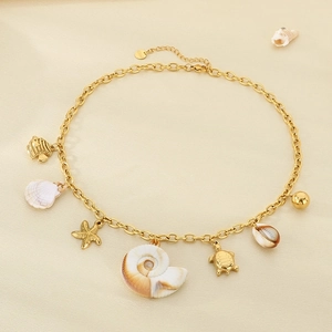 Close-up of ocean-themed charms including starfish, turtle, and shells on a gold chain