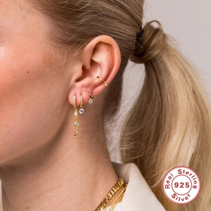 S925 sterling silver gold plated earrings set with cubic zirconia on female model