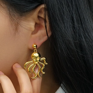 Exaggerated golden octopus earrings in retro metal finish for a vintage beach look