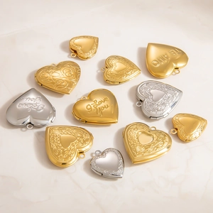 Macro detail of heart locket pendants with polished finish and floral relief patterns