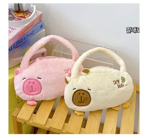 Detail of plush capybara backpacks in pink and white with soft embroidered textures