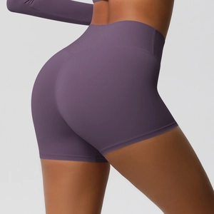 Detail of high waist yoga shorts in dark purple featuring peach butt lifting seam