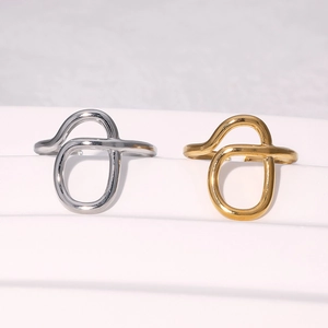 Detail of gold and silver polished stainless steel wrap rings with adjustable open design
