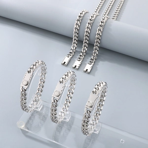 Detailed shot of silver Cuban link chains with unique magnetic clasps on display stands