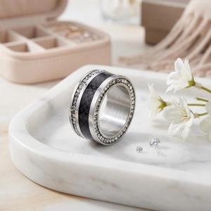 Detail of wide titanium ring with double-row diamonds and black carbon fiber inlay