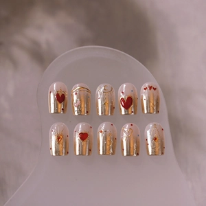 Golden luxury heart nail art stickers with red heart accents and star moon patterns