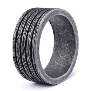 Macro view of wide dark grey industrial ring with vintage textured metal finish