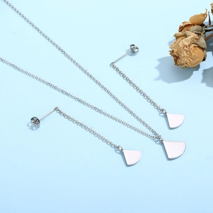 Macro view of silver fan-shaped necklace and earrings set with decorative dried roses