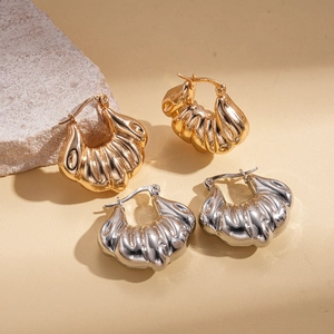Irregular geometric shell-shaped textured metal hoop earrings in gold and silver finish