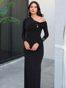 Detail of elegant black knit dress featuring a metallic ring and side shoulder cut-out