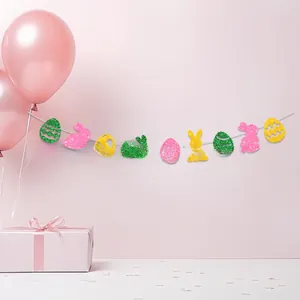 Close-up of glittery Easter banner with colorful bunny and egg shapes for party decor