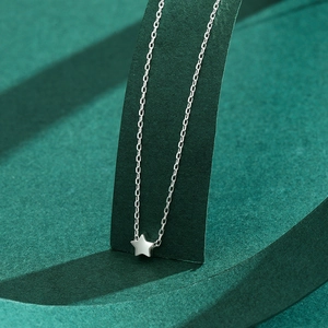 S925 sterling silver star pendant necklace with minimalist chain on green stand