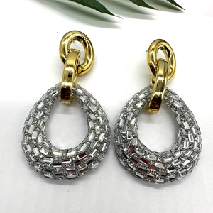 Dramatic rhinestone drop earrings with geometric gold rings and crystal stones