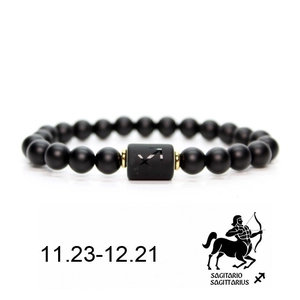 Matte black beaded Sagittarius zodiac bracelet with gold spacers and symbol on white background