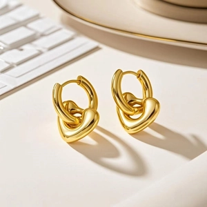 Macro view of gold heart pendant earrings on a minimalist background aesthetic