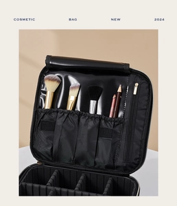 Close-up of internal brush slots and adjustable dividers in the black cosmetic bag