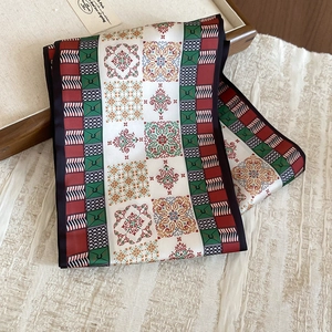 Detail of vintage paisley silk scarf necklace with red and green floral geometric pattern