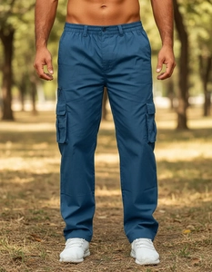 Detailed outdoor shot of dark blue cargo pants showing flap side pockets and straight fit