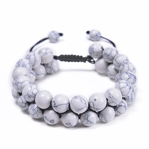 Detail of adjustable double-row white marble stone beaded bracelet with black woven cord