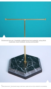 Detail of gold metal T-bar jewelry stand with hexagonal marble base and sturdy welding