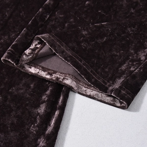 Macro detail of dark brown pleated velvet fabric showing rich texture and stitching