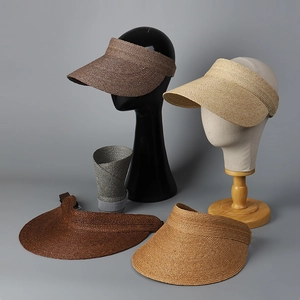 Close-up of premium woven raffia sun visor showing texture and foldable design