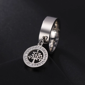 Silver tree of life charm ring with sparkling crystals on a black stand