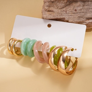Detail view of 10-piece acrylic and metal C-shape earring set on a white display card