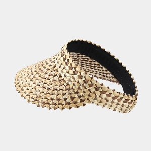 Detail of hand-woven straw visor with brown and beige checkerboard pattern texture