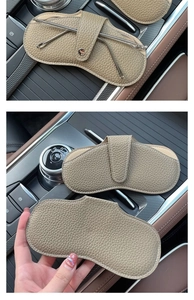 Detail of khaki leather car glasses pouch with metal snap and textured lychee pattern