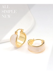 Detailed macro view of 18K gold plated hoop earrings with white marble enamel inlay