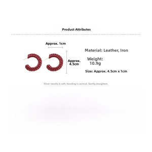 Macro detail of red woven leather C-shaped hoop earrings with size and material labels